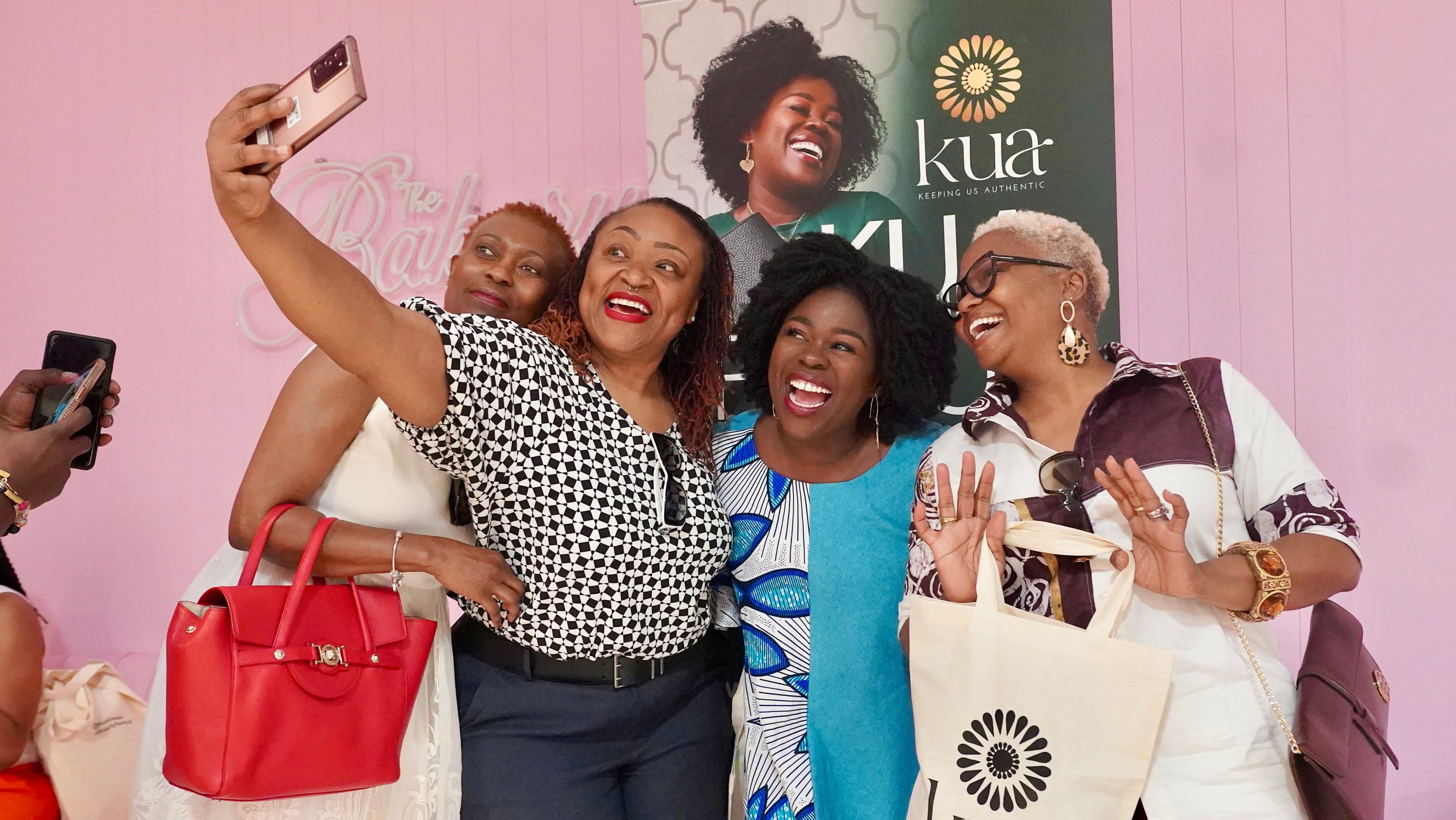 A group of women taking selfie after shopping with Ruby, Kua's founder